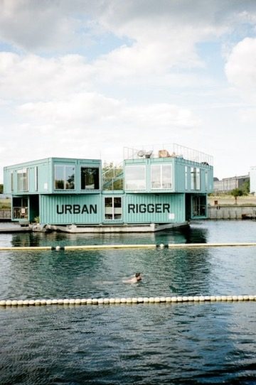 The Urban Rigger floating dorms with a swimmer in the harbor