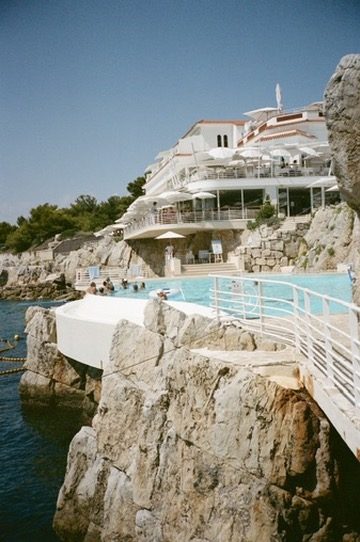 A cliffside pool and terraces stepping down to the sea