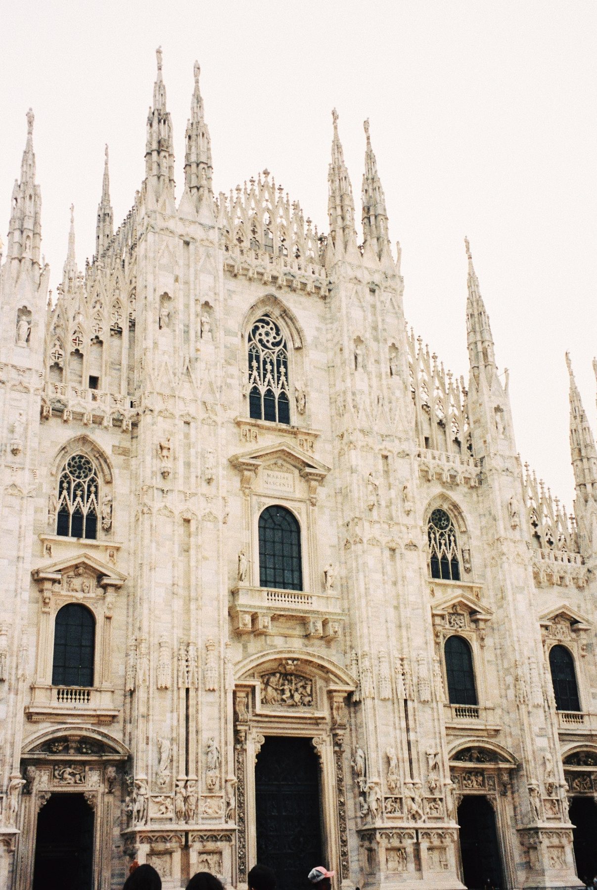 The white marble spires and carved facade of the Duomo di Milano