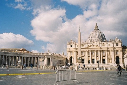 St. Peter's Basilica and its colonnade under big clouds