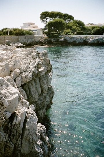 Clear green water against pale limestone rocks